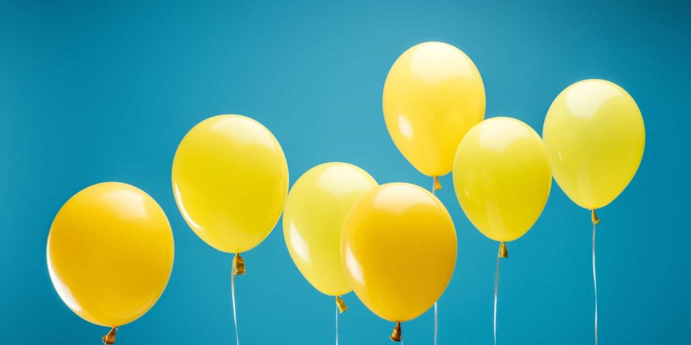 bright party yellow balloons on blue background bright party yellow balloons on blue background