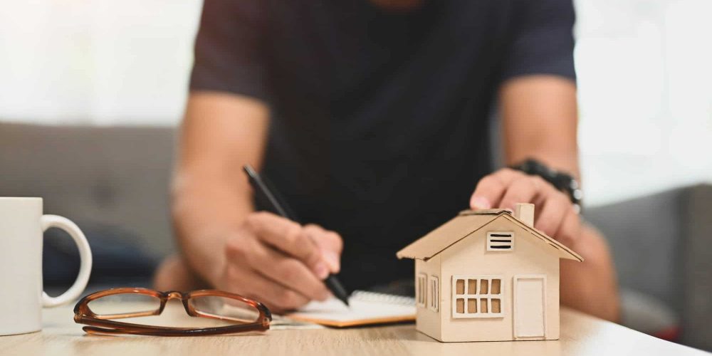 Man planning and calculating money for buy house or estates