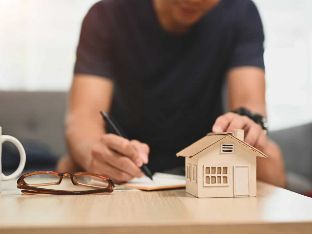 Man planning and calculating money for buy house or estates