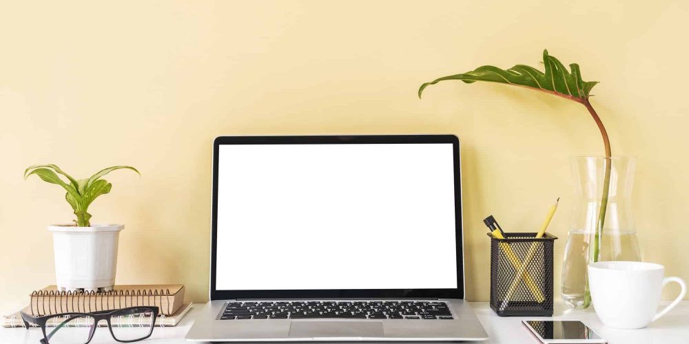 Modern and stylish workspace mock up with laptop and desk office supplies