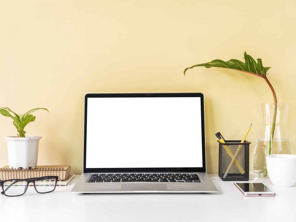 Modern and stylish workspace mock up with laptop and desk office supplies