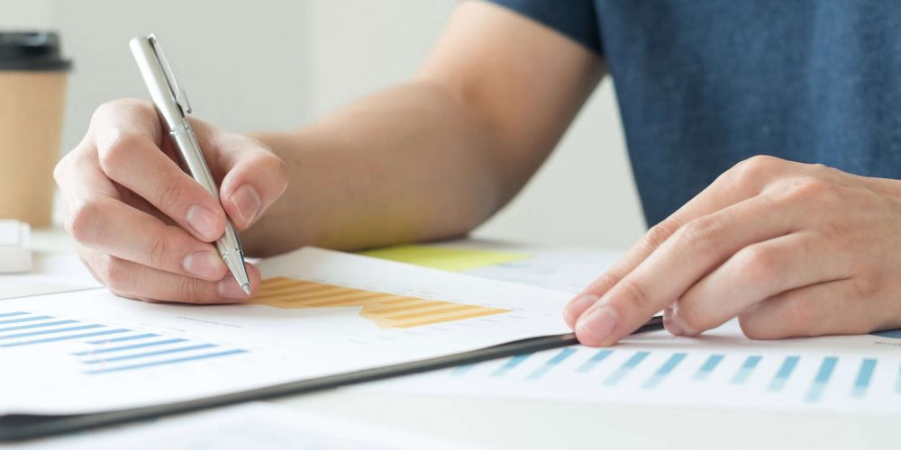 work from home, The hand of a man who works in finance sits at his desk at home and calculates finan work from home, The hand of a man who works in finance sits at his desk at home and calculates finan