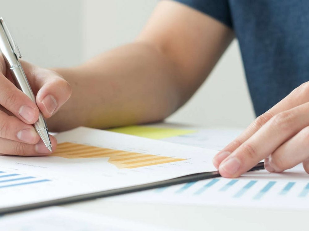 work from home, The hand of a man who works in finance sits at his desk at home and calculates finan